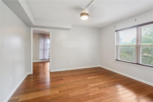 205 Stonehaven Dr, Belle Chasse, LA 70037 - empty room with a textured ceiling and light wood-type flooring