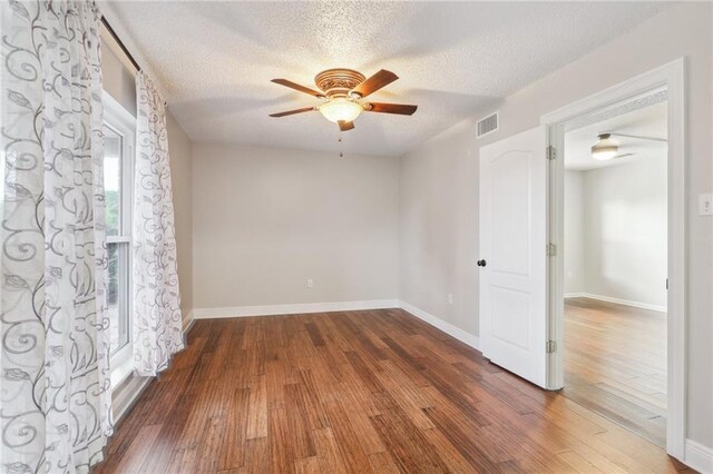 205 Stonehaven Dr, Belle Chasse, LA 70037 - empty room with ceiling fan, dark wood-type flooring, and a textured ceiling
