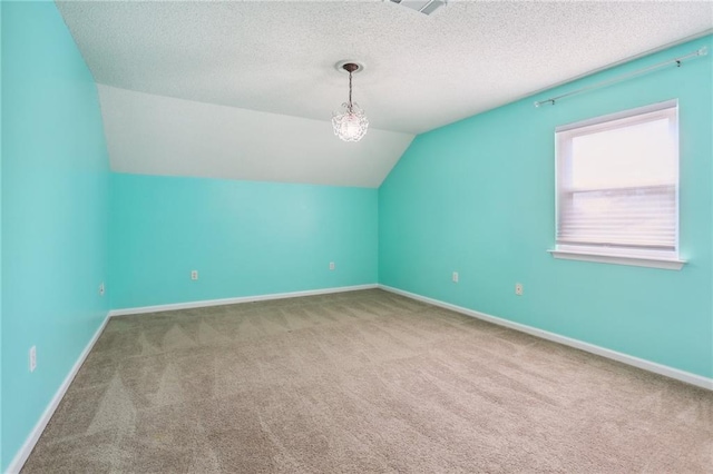 205 Stonehaven Dr, Belle Chasse, LA 70037 - additional living space featuring a textured ceiling, carpet floors, and vaulted ceiling