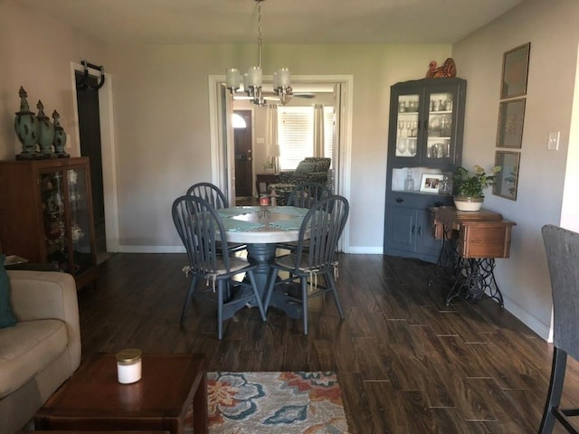 dining area featuring an inviting chandelier and dark hardwood / wood-style floors