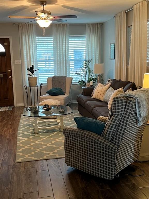 living room featuring ceiling fan and dark hardwood / wood-style flooring