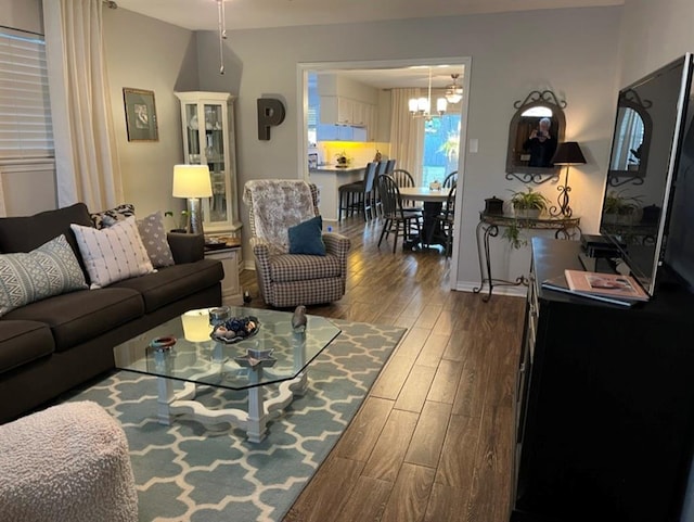 living room featuring hardwood / wood-style floors and an inviting chandelier