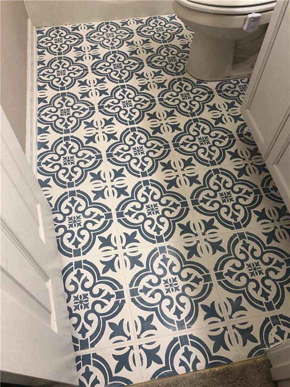 room details featuring toilet and tile patterned flooring