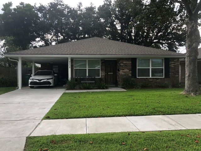 view of front of property with a carport and a front yard