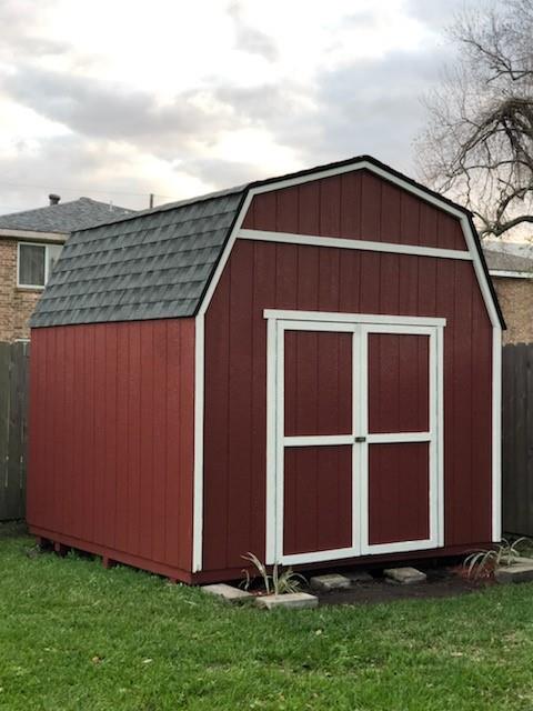 view of outbuilding featuring a yard