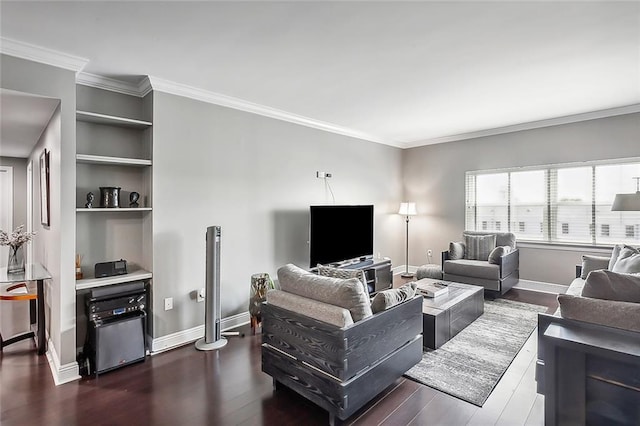 living room with built in shelves, dark hardwood / wood-style floors, and ornamental molding