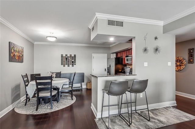 dining room featuring crown molding and dark hardwood / wood-style floors