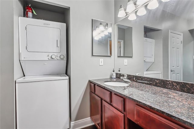 bathroom with stacked washer and dryer and vanity