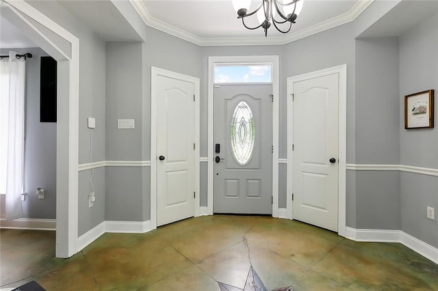 entrance foyer with concrete flooring, a notable chandelier, and crown molding