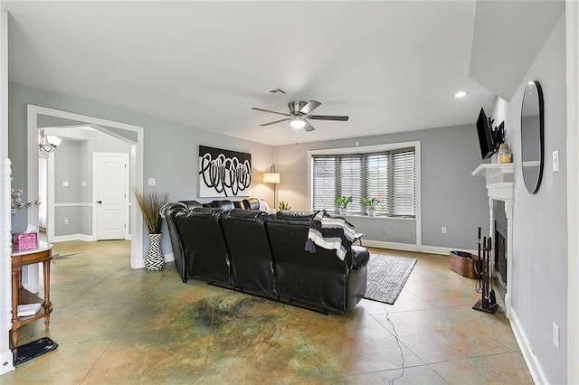 living room featuring concrete floors and ceiling fan