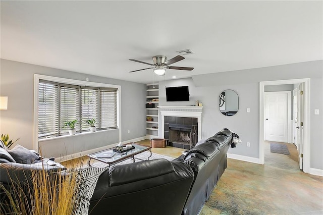 living room with a fireplace and ceiling fan