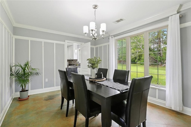 dining room with a notable chandelier and crown molding