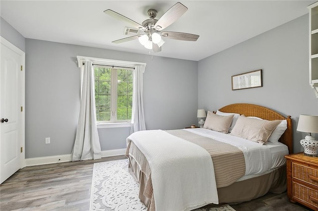 bedroom with ceiling fan and light hardwood / wood-style flooring