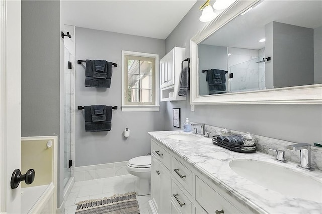 bathroom with vanity, toilet, and a shower with shower door