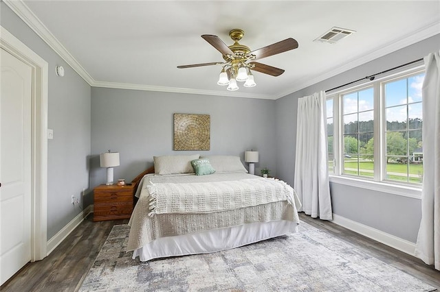 bedroom featuring ceiling fan, dark hardwood / wood-style floors, and ornamental molding