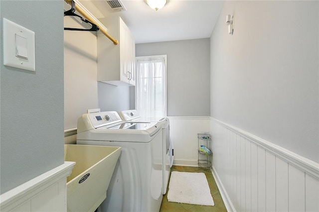 laundry room with sink, independent washer and dryer, and cabinets