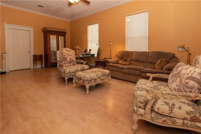 living room featuring hardwood / wood-style floors, ceiling fan, and crown molding