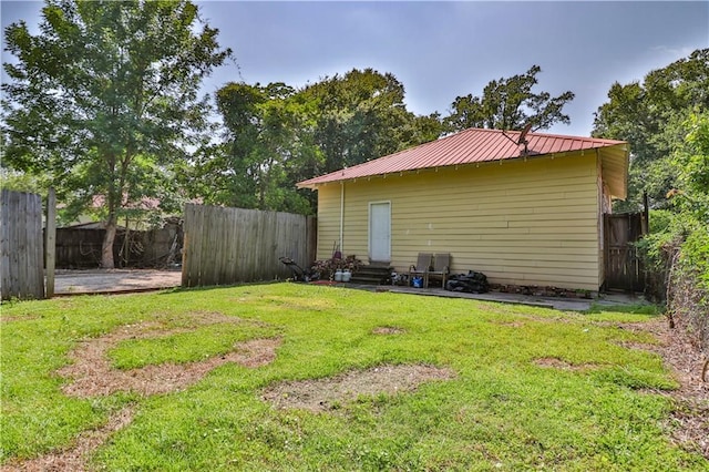 view of yard featuring entry steps and a fenced backyard