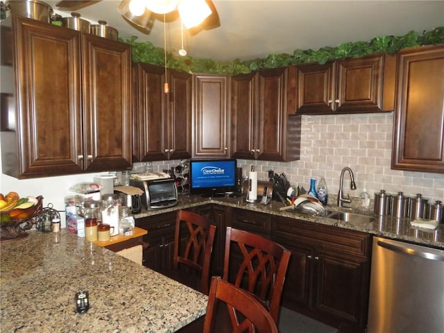 kitchen featuring backsplash, ceiling fan, light stone countertops, stainless steel dishwasher, and sink