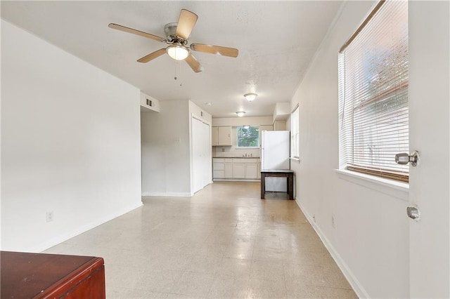 unfurnished living room with ceiling fan