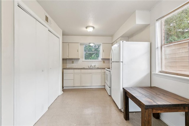 kitchen featuring white cabinetry, white appliances, sink, and tasteful backsplash