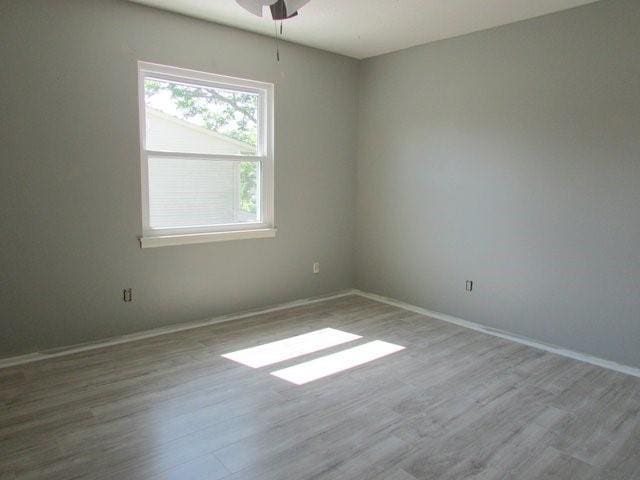 empty room featuring ceiling fan and light wood-type flooring