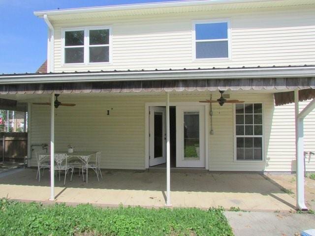 rear view of property featuring ceiling fan and a patio area