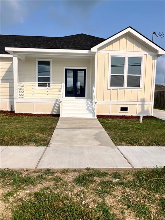 view of front of home with french doors and a front lawn