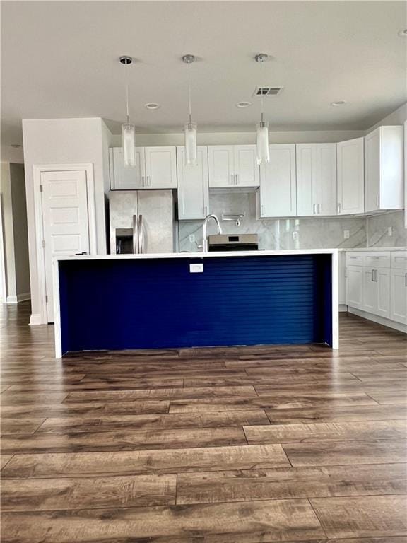 kitchen featuring white cabinets, stainless steel fridge with ice dispenser, and pendant lighting