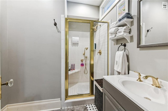 bathroom with vanity and a shower with shower door