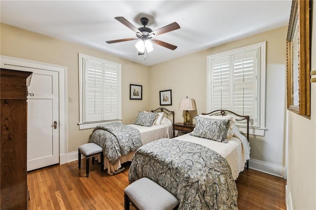 bedroom with ceiling fan and dark wood-type flooring