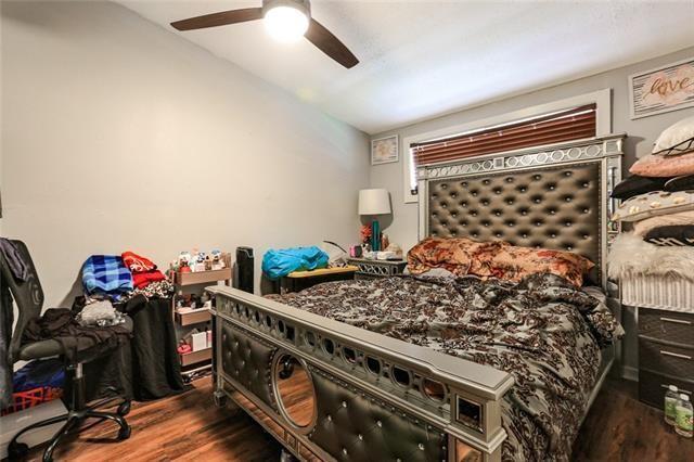 bedroom featuring ceiling fan, dark wood-type flooring, and vaulted ceiling