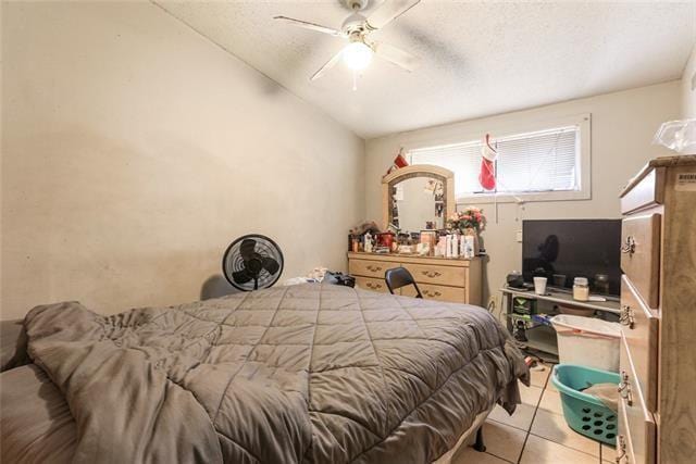 tiled bedroom featuring ceiling fan and vaulted ceiling