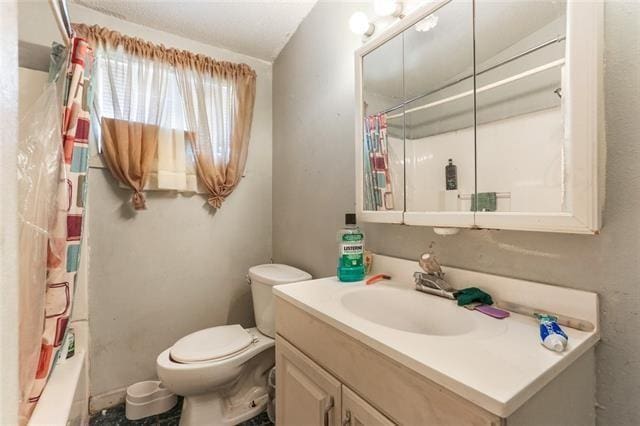 full bathroom featuring vanity, toilet, and shower / bathtub combination with curtain