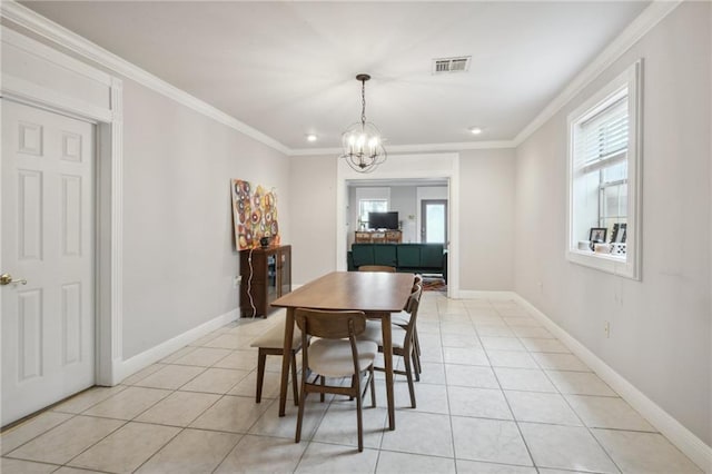 tiled dining area featuring crown molding and a notable chandelier