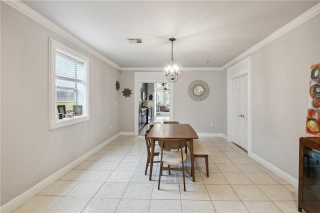 dining room featuring light tile patterned flooring, ornamental molding, and an inviting chandelier