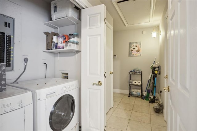 laundry room with light tile patterned floors, electric panel, and washer and clothes dryer