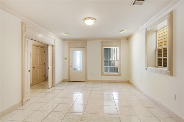 entryway with light tile patterned floors and ornamental molding