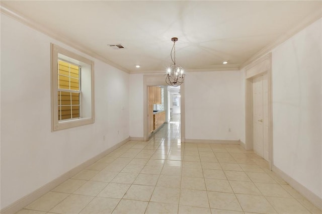 tiled spare room with an inviting chandelier and ornamental molding