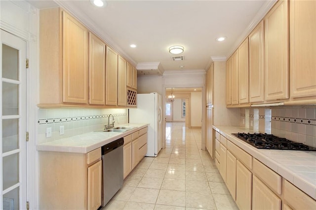 kitchen featuring appliances with stainless steel finishes, light brown cabinets, and tile counters