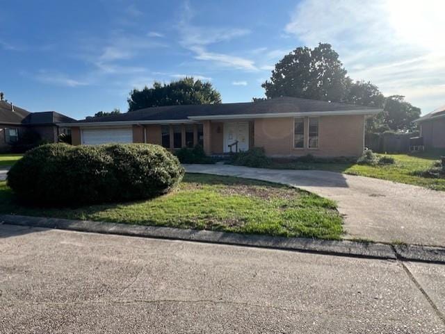 ranch-style home with a garage and a front yard