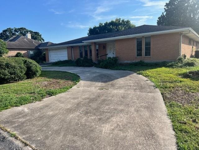 ranch-style home with a garage and a front yard