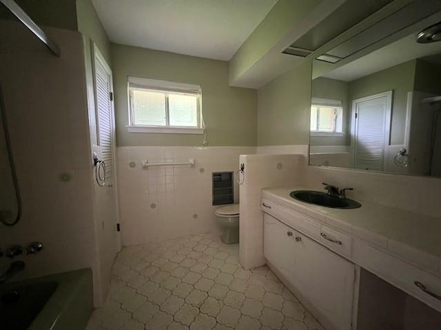 full bathroom featuring vanity, toilet, tile patterned flooring, and bathtub / shower combination