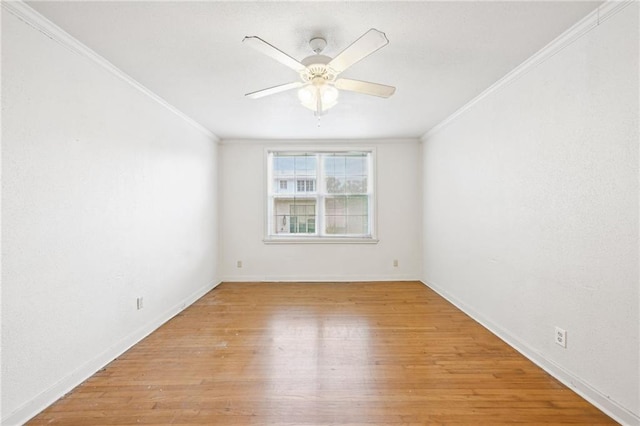 empty room featuring crown molding and light hardwood / wood-style floors