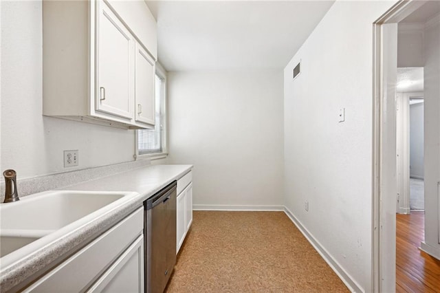 kitchen with white cabinets, dishwasher, light hardwood / wood-style floors, and sink