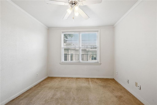 carpeted empty room featuring ceiling fan and crown molding