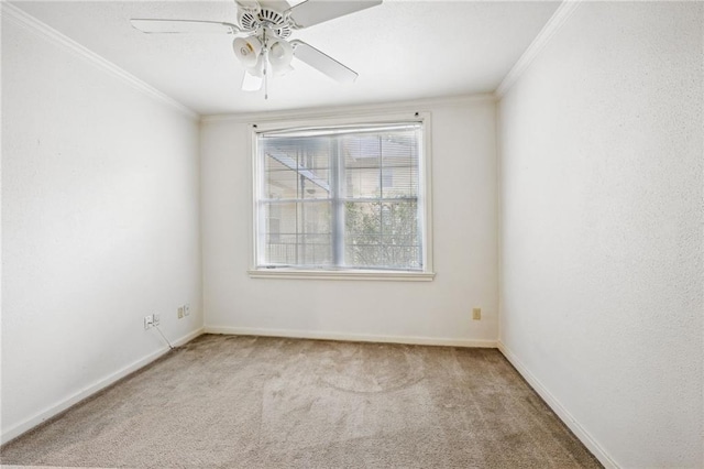 carpeted spare room with crown molding and ceiling fan