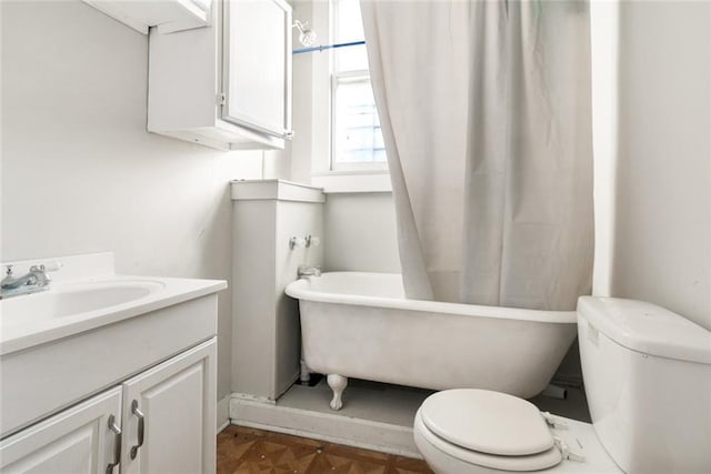 bathroom with parquet flooring, toilet, and vanity