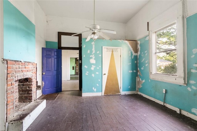 interior space featuring a brick fireplace, ceiling fan, and hardwood / wood-style flooring