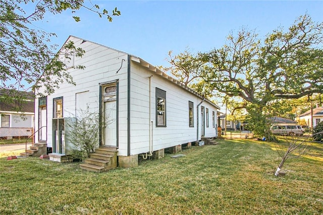 view of side of home featuring a yard